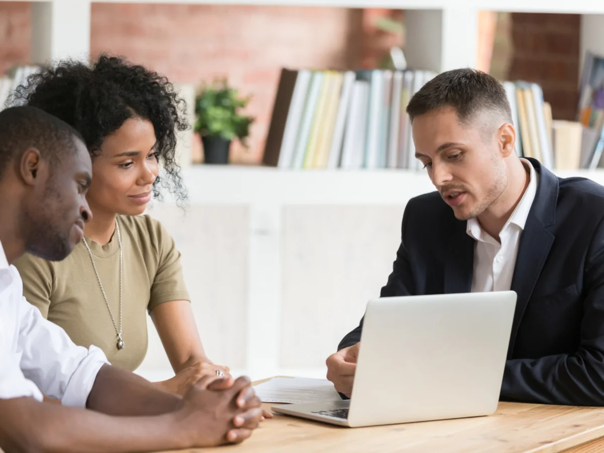 Real estate agent meeting with two buyers
